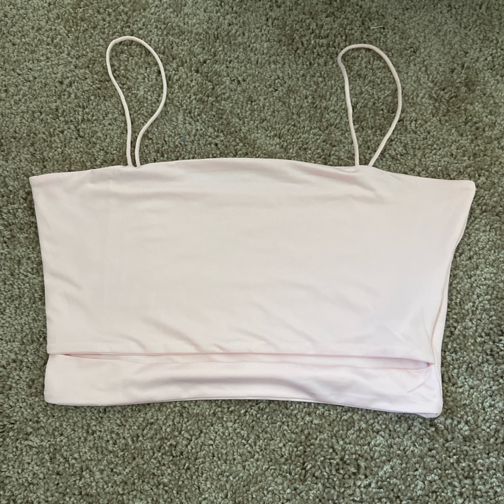 Light pink crop top with slit in it